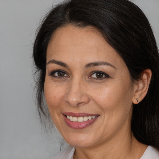 Joyful white adult female with medium  brown hair and brown eyes