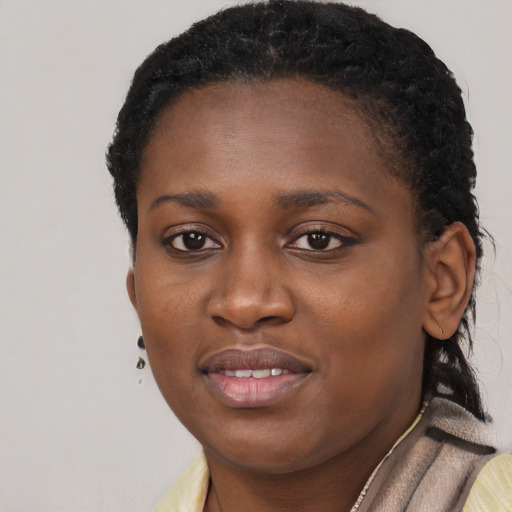 Joyful black young-adult female with short  black hair and brown eyes