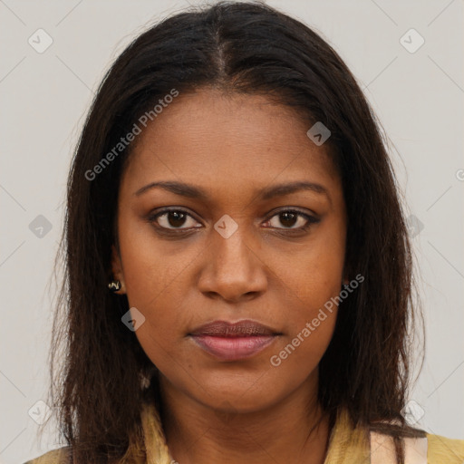 Joyful black young-adult female with long  brown hair and brown eyes