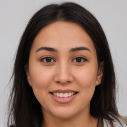 Joyful white young-adult female with long  brown hair and brown eyes