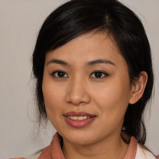 Joyful asian young-adult female with medium  brown hair and brown eyes