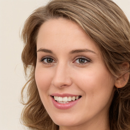 Joyful white young-adult female with long  brown hair and green eyes