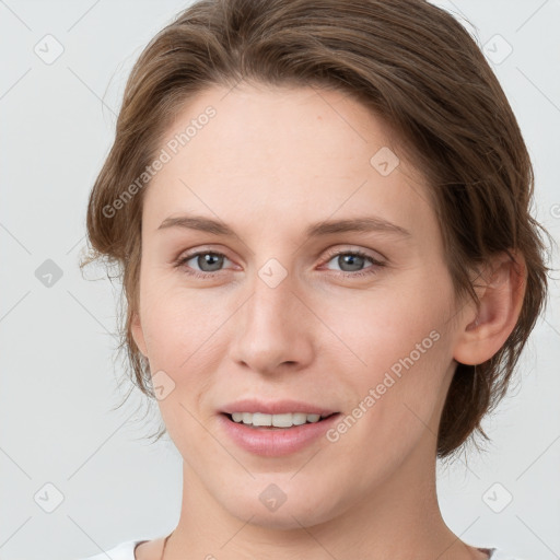 Joyful white young-adult female with medium  brown hair and grey eyes