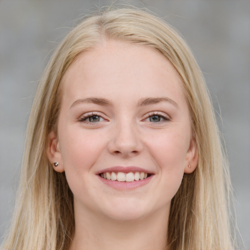 Joyful white young-adult female with long  brown hair and blue eyes