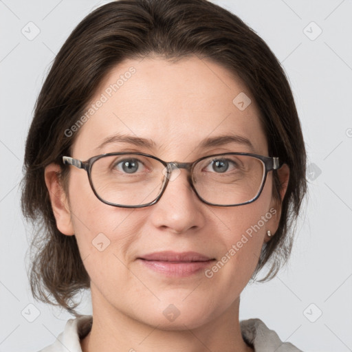 Joyful white adult female with medium  brown hair and grey eyes