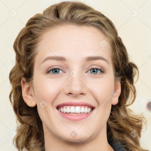 Joyful white young-adult female with long  brown hair and blue eyes