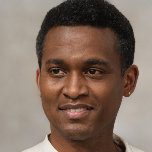 Joyful black young-adult male with short  black hair and brown eyes
