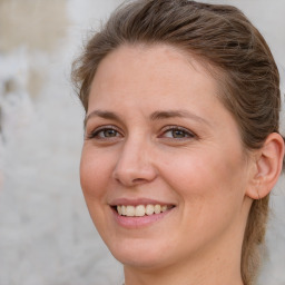 Joyful white adult female with medium  brown hair and grey eyes