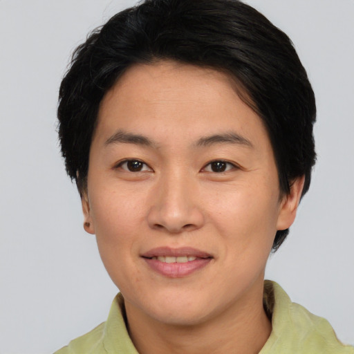 Joyful asian adult female with short  brown hair and brown eyes