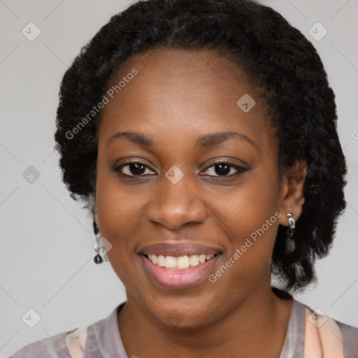 Joyful black young-adult female with long  brown hair and brown eyes