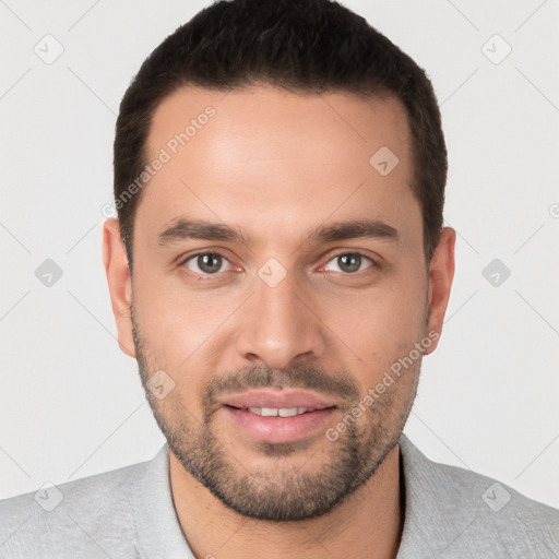 Joyful white young-adult male with short  black hair and brown eyes