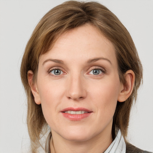 Joyful white young-adult female with medium  brown hair and blue eyes