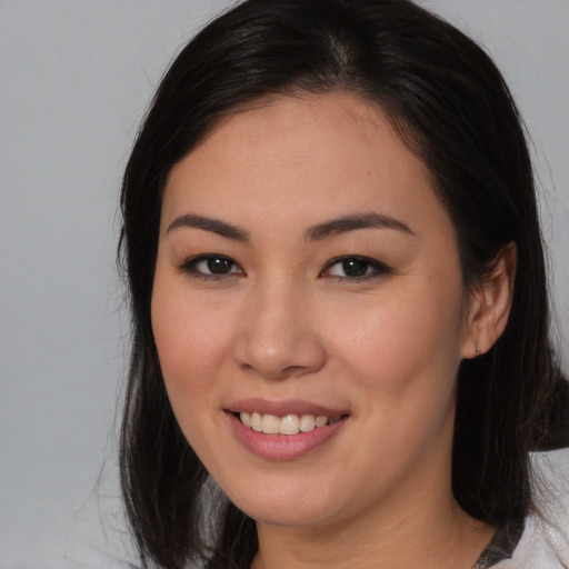 Joyful asian young-adult female with medium  brown hair and brown eyes