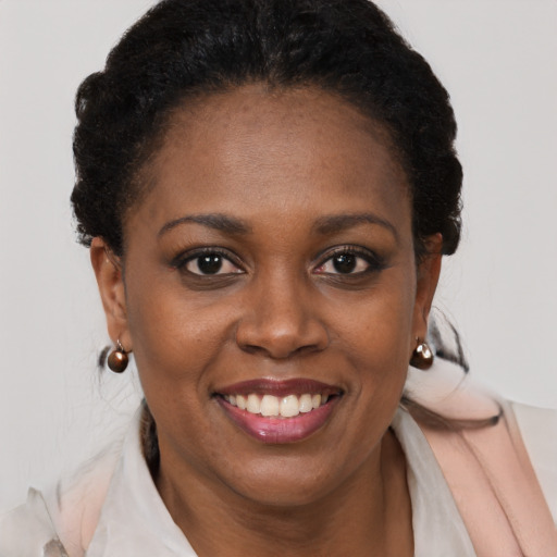 Joyful black young-adult female with short  brown hair and brown eyes