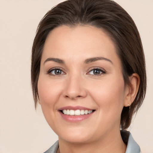 Joyful white young-adult female with medium  brown hair and brown eyes