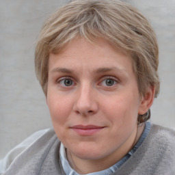 Joyful white young-adult female with short  brown hair and blue eyes