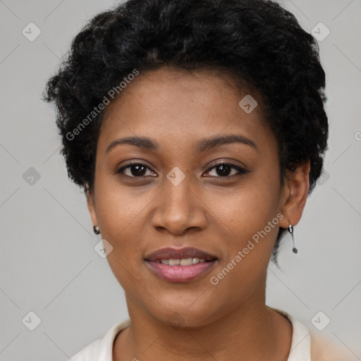 Joyful black young-adult female with short  black hair and brown eyes