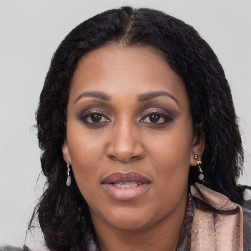 Joyful black young-adult female with long  black hair and brown eyes
