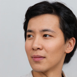 Joyful asian young-adult male with short  black hair and brown eyes