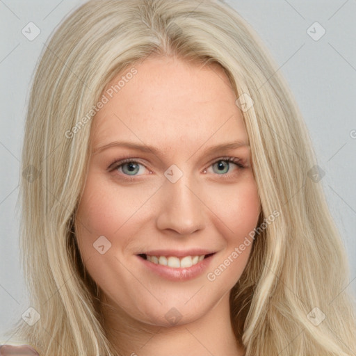 Joyful white young-adult female with long  blond hair and blue eyes