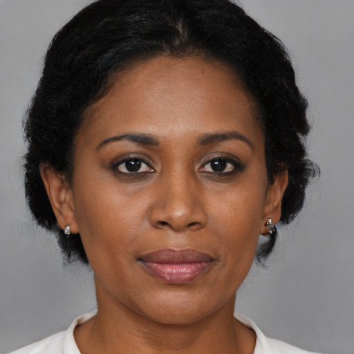 Joyful black adult female with medium  brown hair and brown eyes