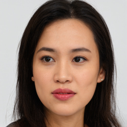 Joyful asian young-adult female with long  brown hair and brown eyes