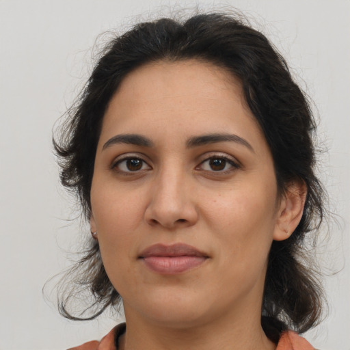 Joyful latino young-adult female with medium  brown hair and brown eyes