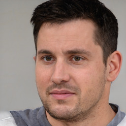 Joyful white adult male with short  brown hair and brown eyes