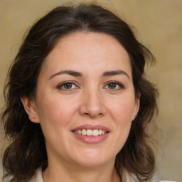 Joyful white adult female with medium  brown hair and brown eyes