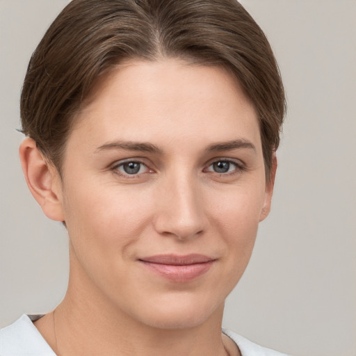 Joyful white young-adult female with short  brown hair and grey eyes