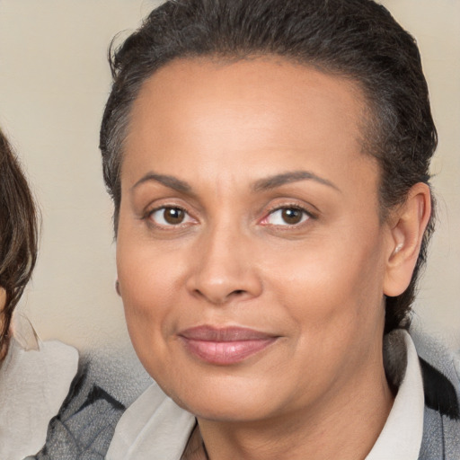 Joyful white adult female with medium  brown hair and brown eyes