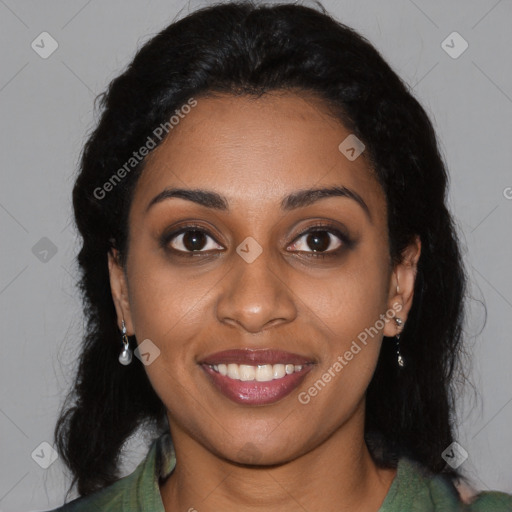 Joyful black young-adult female with long  black hair and brown eyes