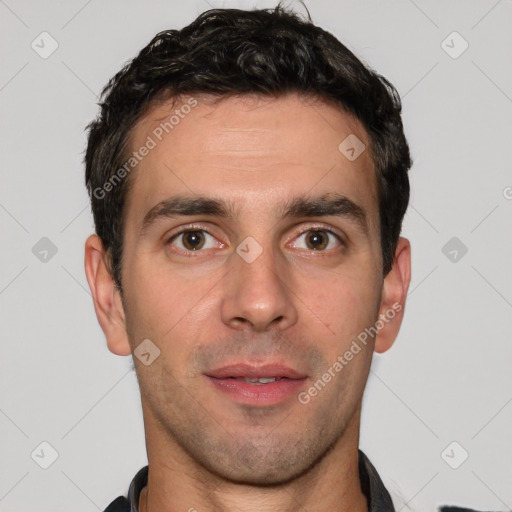 Joyful white young-adult male with short  black hair and brown eyes