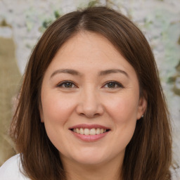 Joyful white young-adult female with medium  brown hair and brown eyes