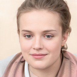 Joyful white young-adult female with long  brown hair and blue eyes