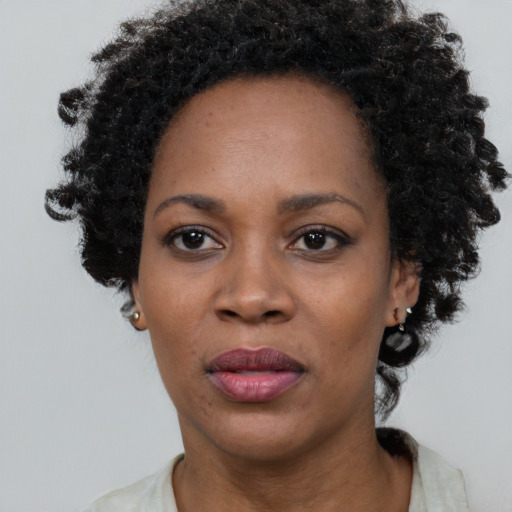Neutral black adult female with short  black hair and brown eyes