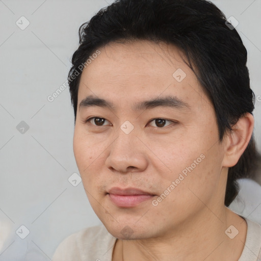 Joyful asian young-adult male with short  black hair and brown eyes