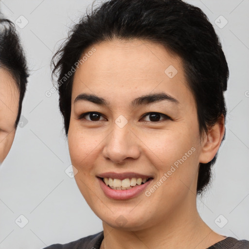 Joyful asian young-adult female with short  brown hair and brown eyes