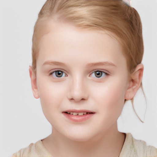 Joyful white child female with short  brown hair and blue eyes