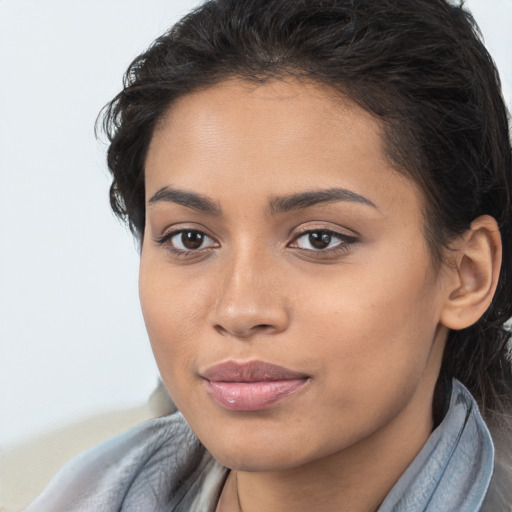 Joyful latino young-adult female with long  brown hair and brown eyes