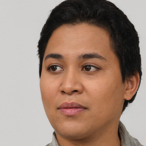 Joyful latino young-adult female with short  black hair and brown eyes