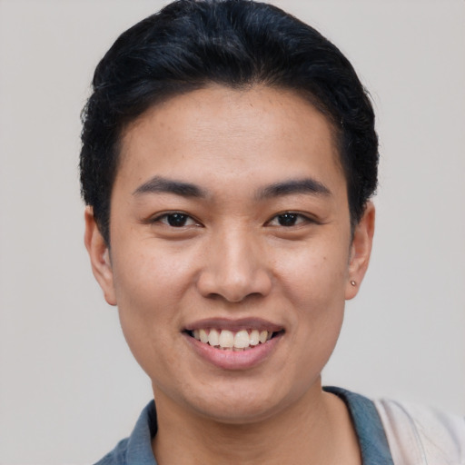 Joyful asian young-adult male with short  black hair and brown eyes