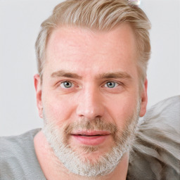 Joyful white adult male with short  brown hair and blue eyes