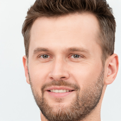 Joyful white young-adult male with short  brown hair and brown eyes