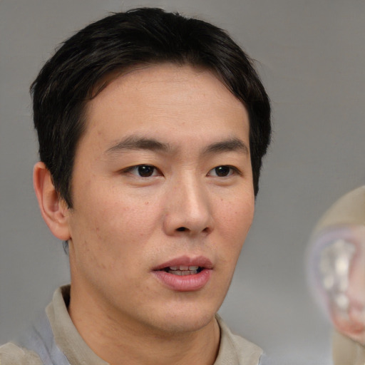 Neutral asian young-adult male with short  brown hair and brown eyes