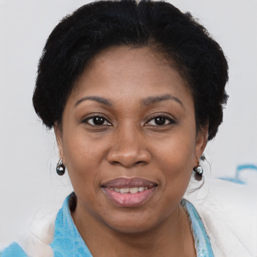 Joyful black adult female with short  brown hair and brown eyes