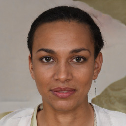 Joyful black young-adult female with short  black hair and brown eyes
