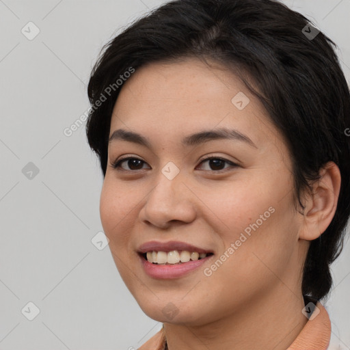 Joyful asian young-adult female with medium  black hair and brown eyes