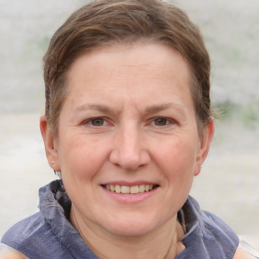 Joyful white adult female with short  brown hair and grey eyes