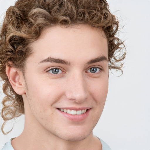 Joyful white young-adult male with short  brown hair and blue eyes